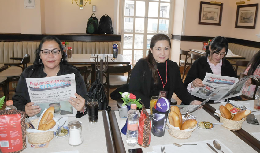 Grupo de personas desayunando.